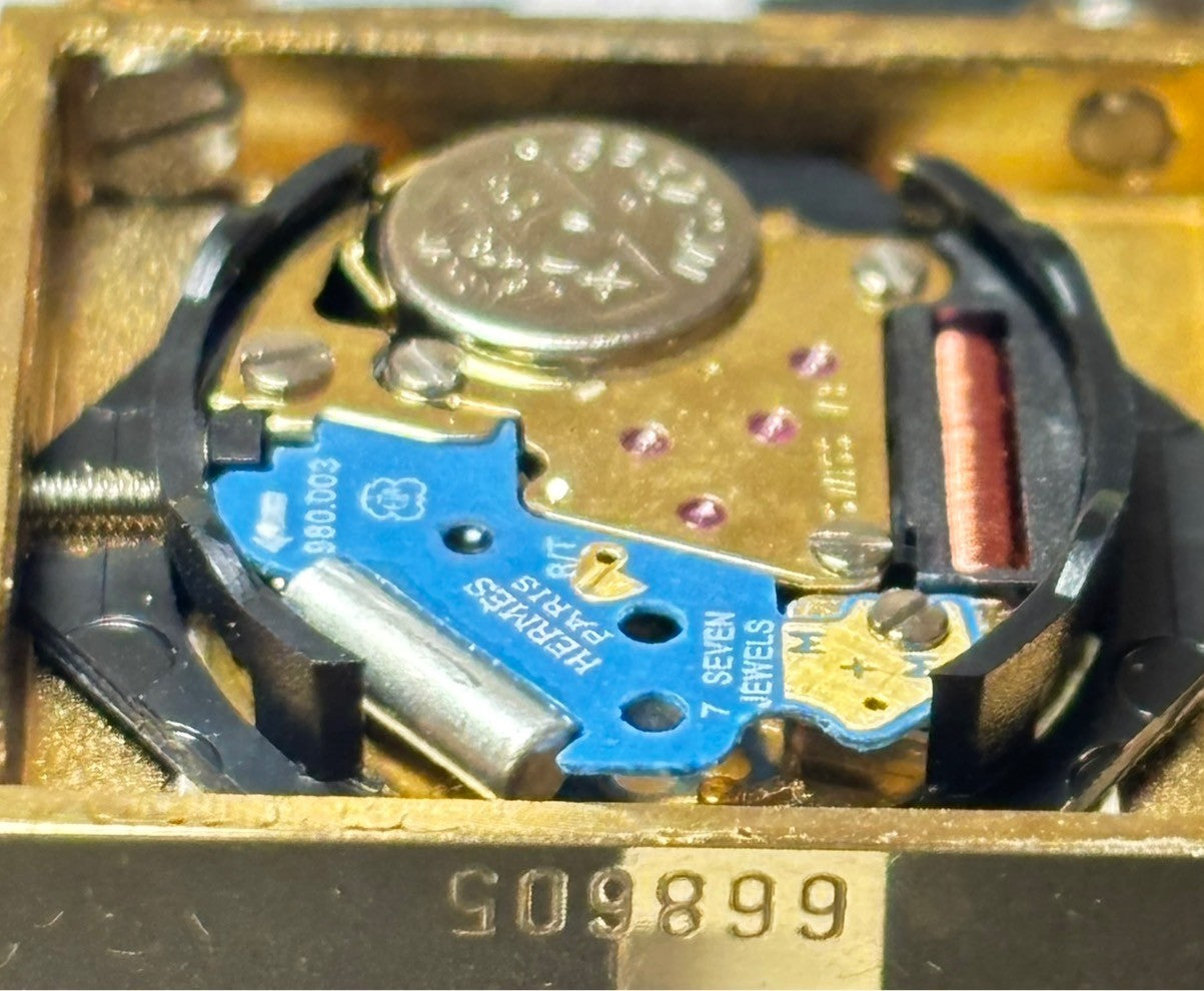 7696071