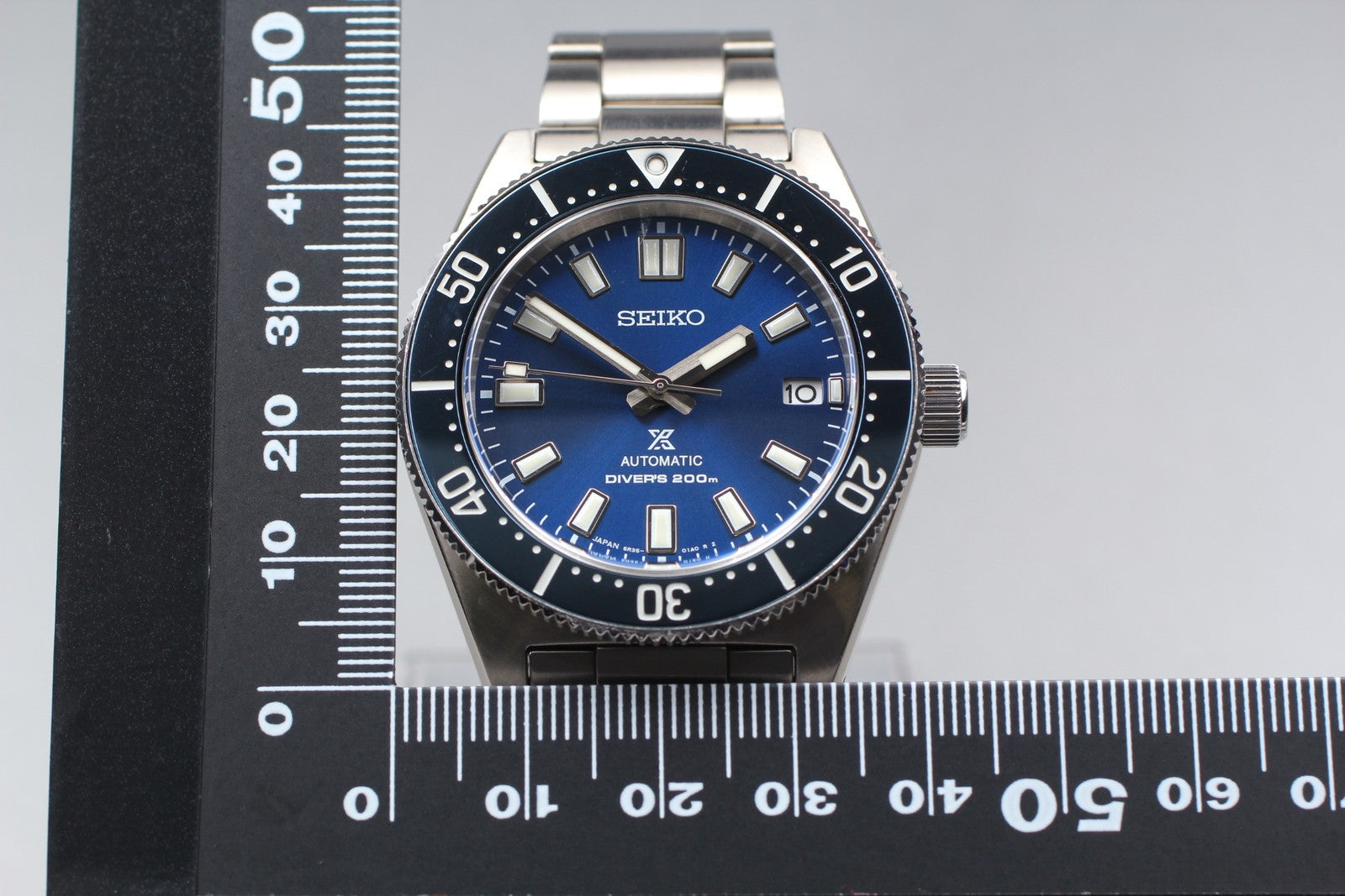 7696059